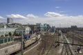 Railway station with many railway tracks and modern trains with cars on the background of the city buildings Royalty Free Stock Photo