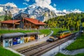 Railway station with mountains and retro tourist train, Murren, Switzerland Royalty Free Stock Photo