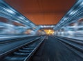 Railway station at night with motion blur effect. Railroad Royalty Free Stock Photo