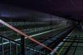 Railway station at night with a passing train Royalty Free Stock Photo