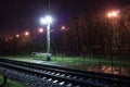 Railway station at night with a passing train Royalty Free Stock Photo