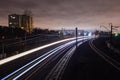 Railway station at night with a passing train Royalty Free Stock Photo