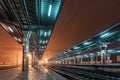 Railway station at night. Train platform in fog. Railroad Royalty Free Stock Photo