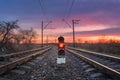 Railway station with semaphore against beautiful sky at sunset Royalty Free Stock Photo