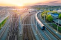 Railway station with wagons during sunrise from above. Reconstructed modern railway infrastructure