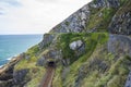 Railway through stone rocks mountain at Irish seacoast Royalty Free Stock Photo