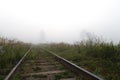 Railway to horizon in fog Royalty Free Stock Photo