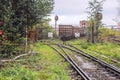 The the railway track abuts against closed lattice metal gates, behind which the rails diverge in two different