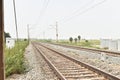 Railway track with the background of sky, and green trees on both sides of the track Royalty Free Stock Photo