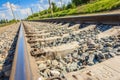 Railway track close-up view. Rural areas. Beautiful sky with clouds. Siberian landscape