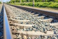 Railway track close-up view. Rural areas. Beautiful sky with clouds. Siberian landscape