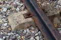 Railway track of iron rails old rusty and cement sleeper against a gravel background Royalty Free Stock Photo