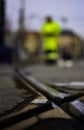 Railway track junction and worker man in the background