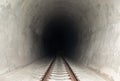 Railway track leading lines into the dark train tunnel entrance Royalty Free Stock Photo