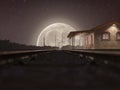 The railway track on a misty night with a full moon Royalty Free Stock Photo