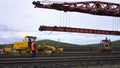 Railway track repair with tractor and railway crane