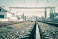 Railway tracks in the city with track bed. Gravel and switch at a railroad crossing Royalty Free Stock Photo