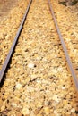 Railway tracks close up against the background of the stone ground. Royalty Free Stock Photo