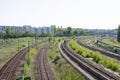 Railway tracks curve, with cityscape in the background Royalty Free Stock Photo