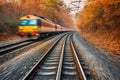 railway tracks curving ahead with speeding train