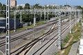 Railway tracks go into the distance. Railway power lines. Lines, diagonals, rhythm. City. Industrial landscape.