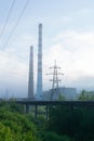 Railway tracks going into the fog, pipelines and chimneys in the haze Royalty Free Stock Photo