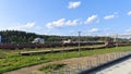 Railway tracks have been laid and electrified at the station with administrative buildings among the grassy lawns. There are train Royalty Free Stock Photo