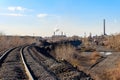 Railway tracks in industrial zone with factories Royalty Free Stock Photo