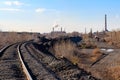 Railway tracks in industrial zone with factories Royalty Free Stock Photo