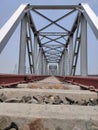 Railway tracks iron bridge unique angle shot with flat sky Royalty Free Stock Photo