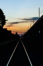 Railway tracks in the shadow light of sunset. Royalty Free Stock Photo