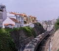 Railway tracks in the suburbs of Lisbon with a moving train Royalty Free Stock Photo