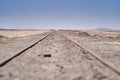 railway tracks to nowhere leading straight to the horizon in the atacama desert Royalty Free Stock Photo