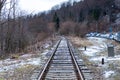 Railway tracks with trees in the mountains. Binaries tracks in winter with snow and woods in easter europe Royalty Free Stock Photo