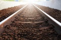 Railway tracks vanishing into light