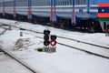 Railway traffic light on the background of a modern train. fast train at the railway station, will take to any part of the world. Royalty Free Stock Photo