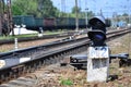 Railway traffic light semaphore against the background of a day railway landscape. Signal device on the railway track Royalty Free Stock Photo