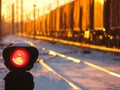 Railway traffic light shows blue signal on railway and railway with freight train as the background Royalty Free Stock Photo