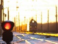 Railway traffic light shows blue signal on railway and railway with freight train as the background Royalty Free Stock Photo