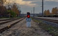 Railway traffic lights between rail tracks, showing a red stop signal Royalty Free Stock Photo