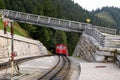 The railway with a train under the bridge on the mountains view. Royalty Free Stock Photo