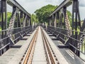 Railway trains track on metal bridge with trees and sky