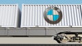 Railway transportation of containers with BMW logo. Editorial 3D rendering