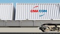 Railway transportation of containers with CMA CGM logo. Editorial 3D rendering