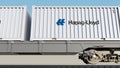 Railway transportation of containers with Hapag-Lloyd logo. Editorial 3D rendering