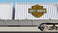 Railway transportation of containers with Harley-Davidson, Inc. logo. Editorial 3D rendering