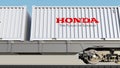 Railway transportation of containers with Honda logo. Editorial 3D rendering