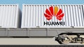 Railway transportation of containers with Huawei logo. Editorial 3D rendering