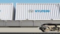 Railway transportation of containers with Hyundai Motor Company logo. Editorial 3D rendering