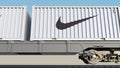 Railway transportation of containers with Nike inscription and logo. Editorial 3D rendering